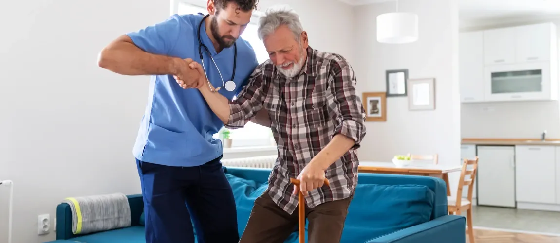 Pflegekraft stützt Patient.